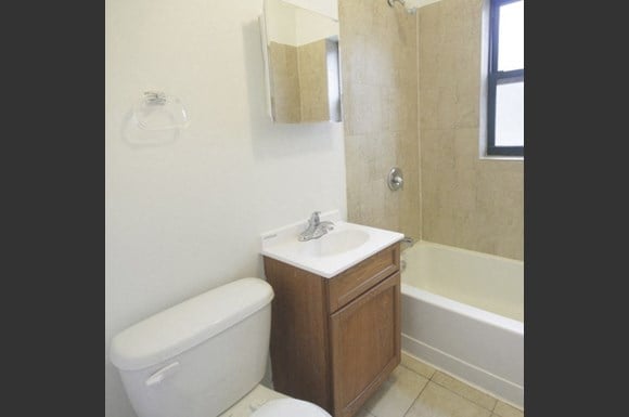 a bathroom with a toilet and a sink and a tub